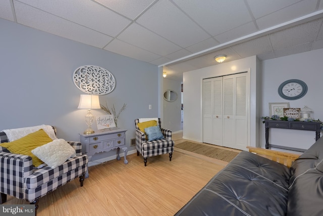 402 Swamp Rd, Morgantown, PA 19543 - living area with a paneled ceiling, wood finished floors, and baseboards