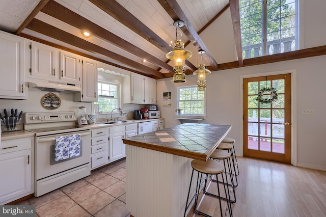 402 Swamp Rd, Morgantown, PA 19543 - kitchen featuring white appliances, under cabinet range hood, a sink, tile countertops, and white cabinetry