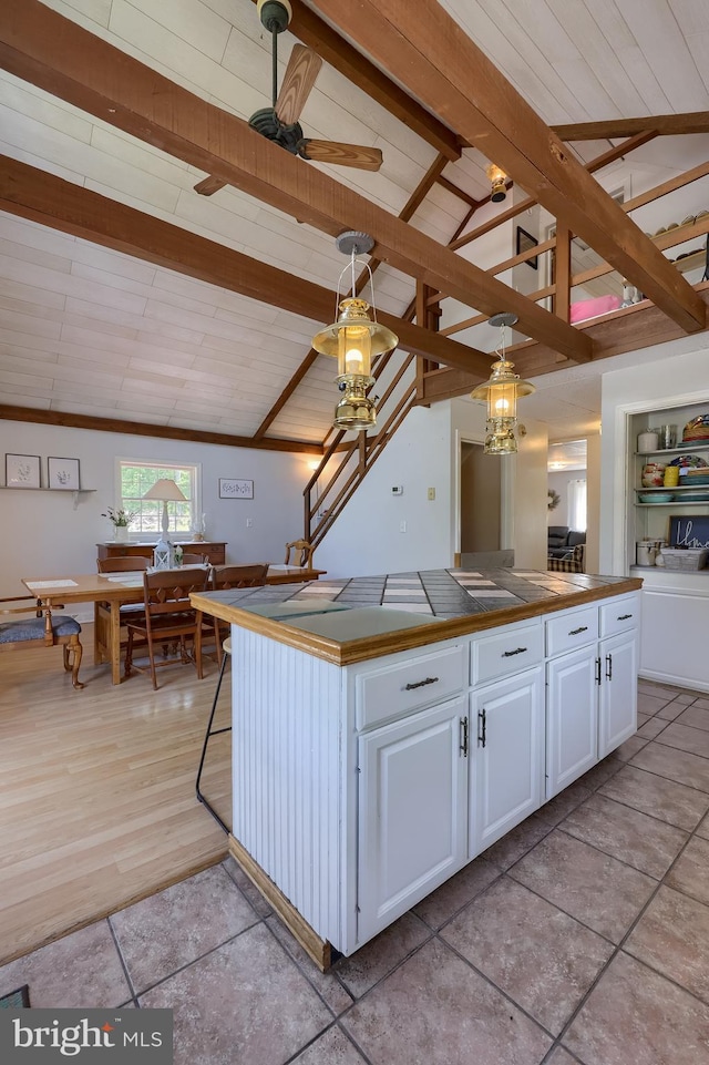 402 Swamp Rd, Morgantown, PA 19543 - kitchen featuring a ceiling fan, white cabinetry, and a kitchen island