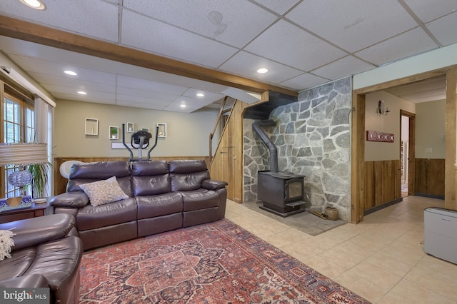 402 Swamp Rd, Morgantown, PA 19543 - tiled living room with a paneled ceiling, wainscoting, a wood stove, recessed lighting, and stairs