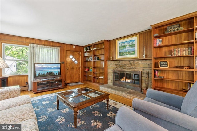 161 Bull Run Rd, Pennington, NJ 08534 - living room with a stone fireplace, wood finished floors, a baseboard heating unit, and wooden walls