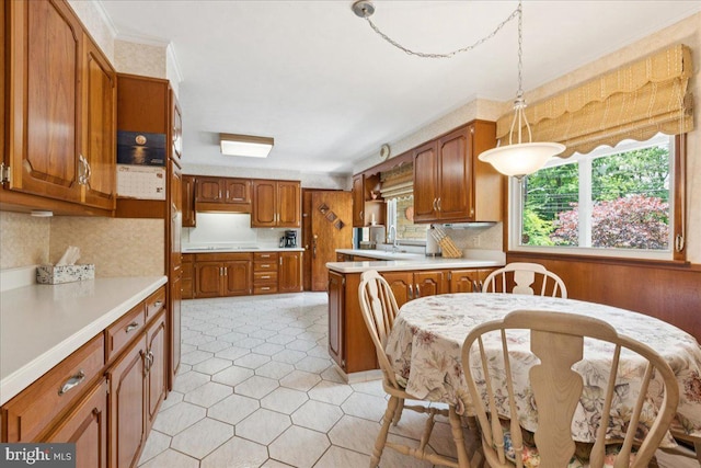 161 Bull Run Rd, Pennington, NJ 08534 - kitchen featuring light countertops, brown cabinets, decorative backsplash, light tile patterned floors, and pendant lighting