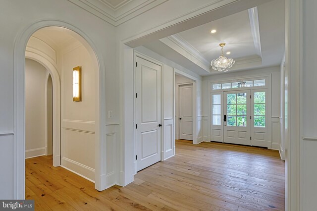 4740 34th Rd N, Arlington, VA 22207 - entrance foyer featuring ornamental molding, a chandelier, arched walkways, light wood finished floors, and a decorative wall