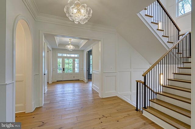 4740 34th Rd N, Arlington, VA 22207 - foyer featuring a chandelier, a decorative wall, light wood-type flooring, stairway, and ornamental molding