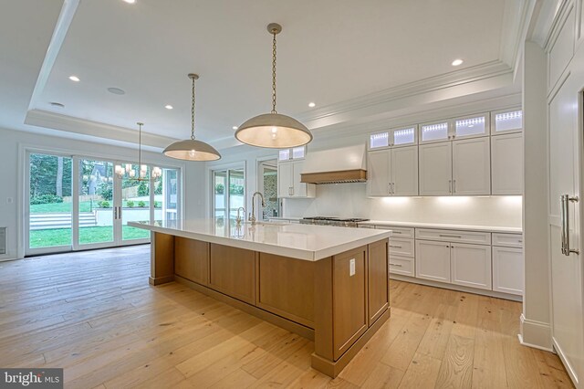 4740 34th Rd N, Arlington, VA 22207 - kitchen with crown molding, a sink, light wood-type flooring, light countertops, and wall chimney range hood