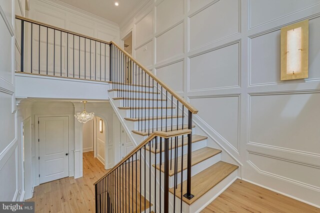 4740 34th Rd N, Arlington, VA 22207 - stairway featuring a decorative wall, wood finished floors, a chandelier, crown molding, and recessed lighting