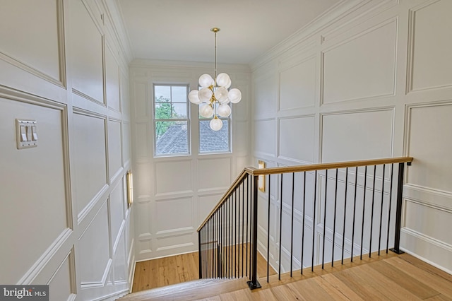 4740 34th Rd N, Arlington, VA 22207 - stairway featuring a decorative wall, wood finished floors, a chandelier, and ornamental molding