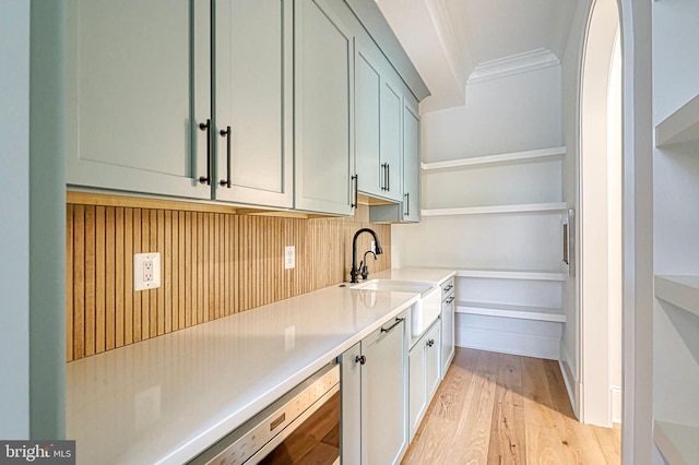 4740 34th Rd N, Arlington, VA 22207 - kitchen with a sink, light wood-style floors, tasteful backsplash, crown molding, and light countertops