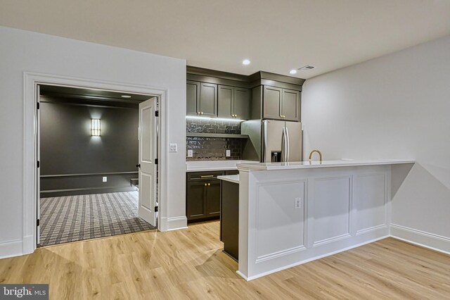 4740 34th Rd N, Arlington, VA 22207 - kitchen with stainless steel fridge with ice dispenser, light wood finished floors, light countertops, decorative backsplash, and recessed lighting