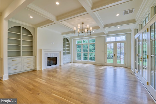 4740 34th Rd N, Arlington, VA 22207 - unfurnished living room with french doors, a tile fireplace, crown molding, a chandelier, and light wood-style flooring