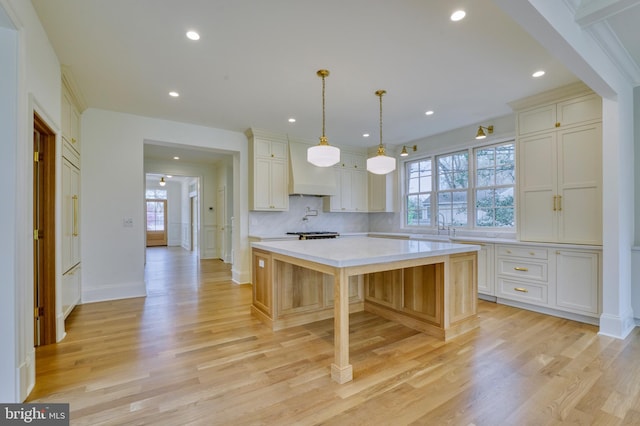 4740 34th Rd N, Arlington, VA 22207 - kitchen with light countertops, light wood-type flooring, a kitchen island, decorative backsplash, and recessed lighting