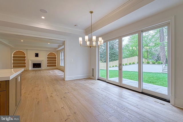 4740 34th Rd N, Arlington, VA 22207 - unfurnished dining area featuring a chandelier, crown molding, light wood-style floors, a fireplace, and baseboards