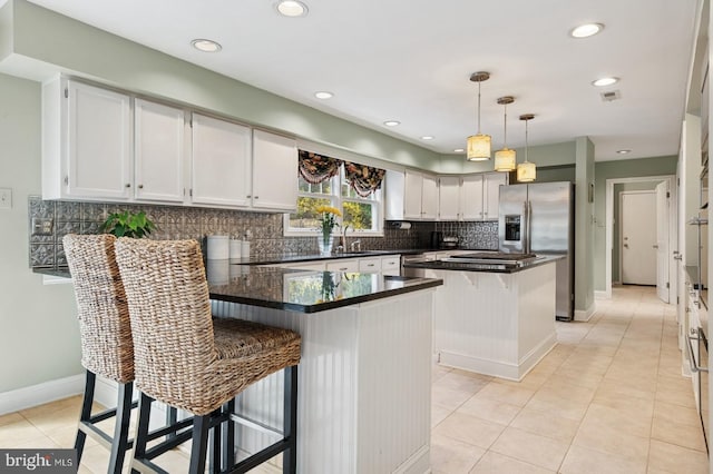 6 Keystone Way, Princeton Junction, NJ 08550 - kitchen with a peninsula, stainless steel appliances, tasteful backsplash, dark countertops, and light tile patterned floors
