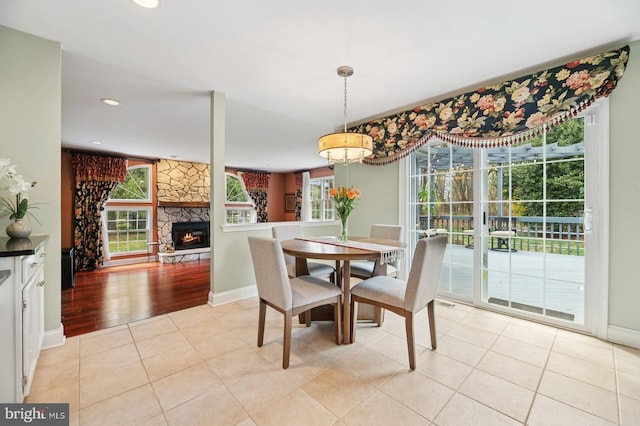6 Keystone Way, Princeton Junction, NJ 08550 - dining space with light tile patterned floors, baseboards, a stone fireplace, and recessed lighting