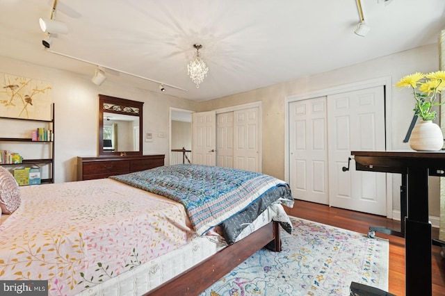 6 Keystone Way, Princeton Junction, NJ 08550 - bedroom featuring rail lighting, multiple closets, wood finished floors, and a chandelier