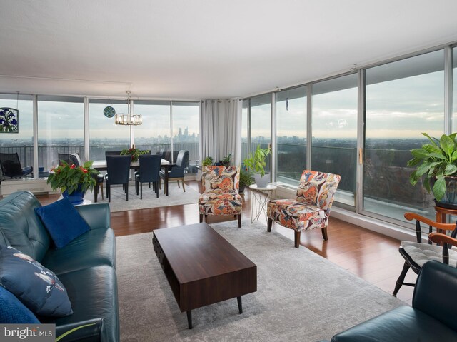 3900 Ford Rd Unit 21E & 20E, Philadelphia, PA 19131 - living room with wood finished floors, a chandelier, and a wall of windows