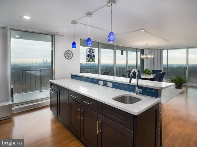 3900 Ford Rd Unit 21E & 20E, Philadelphia, PA 19131 - kitchen featuring a sink, floor to ceiling windows, dark wood-type flooring, decorative light fixtures, and dark brown cabinetry
