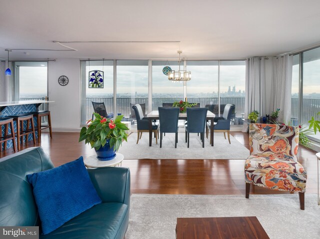 3900 Ford Rd Unit 21E & 20E, Philadelphia, PA 19131 - living room with wood finished floors, a chandelier, and floor to ceiling windows