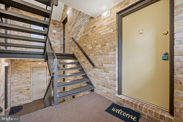 10528 Cross Fox Ln Unit D-2, Columbia, MD 21044 - staircase featuring brick wall and carpet floors