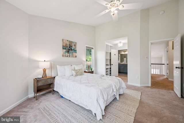 5071 Columbia Rd, Columbia, MD 21044 - bedroom featuring light carpet, high vaulted ceiling, baseboards, and ensuite bathroom