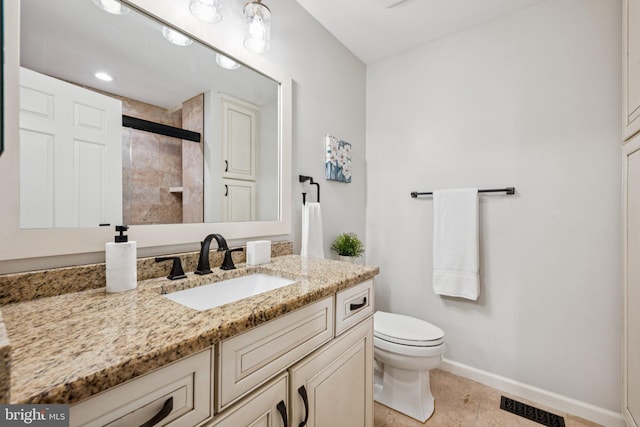5071 Columbia Rd, Columbia, MD 21044 - bathroom with vanity, toilet, a tile shower, baseboards, and tile patterned flooring