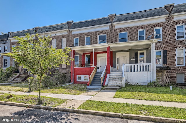 3711 Spaulding Ave, Baltimore, MD 21215 - view of property featuring brick siding, covered porch, and stairway