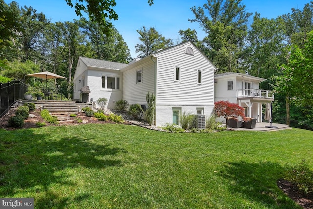 4604 Park Rd, Alexandria, VA 22312 - back of property with a balcony, a patio area, and brick siding