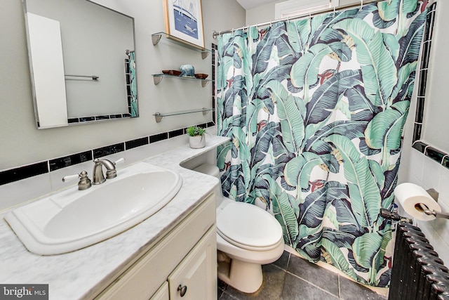 1441 Euclid St NW Unit 105, Washington, DC 20009 - full bathroom featuring vanity, toilet, a shower with curtain, tile walls, and backsplash