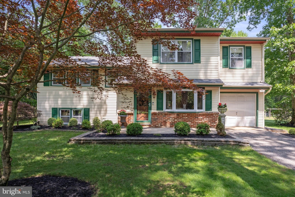 155 Ridge Rd, Southampton, NJ 08088 - view of front of house featuring a garage, driveway, a front yard, and brick siding
