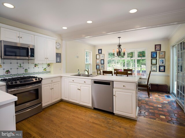 825 Parkes Run Ln, Villanova, PA 19085 - kitchen featuring appliances with stainless steel finishes, a peninsula, a sink, white cabinetry, and a chandelier