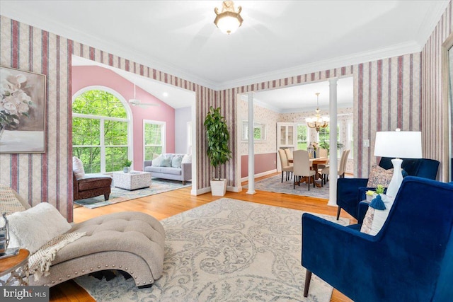10840 Wolfsville Rd, Myersville, MD 21773 - living area with wallpapered walls, crown molding, ornate columns, wood finished floors, and a chandelier