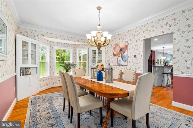10840 Wolfsville Rd, Myersville, MD 21773 - dining area featuring light wood finished floors, wallpapered walls, a chandelier, crown molding, and baseboards