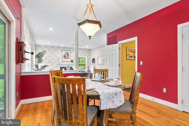 10840 Wolfsville Rd, Myersville, MD 21773 - dining area with light wood-style flooring, baseboards, wallpapered walls, and plenty of natural light