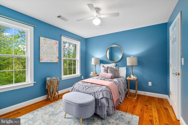 10840 Wolfsville Rd, Myersville, MD 21773 - bedroom with multiple windows, baseboards, wood finished floors, and a ceiling fan