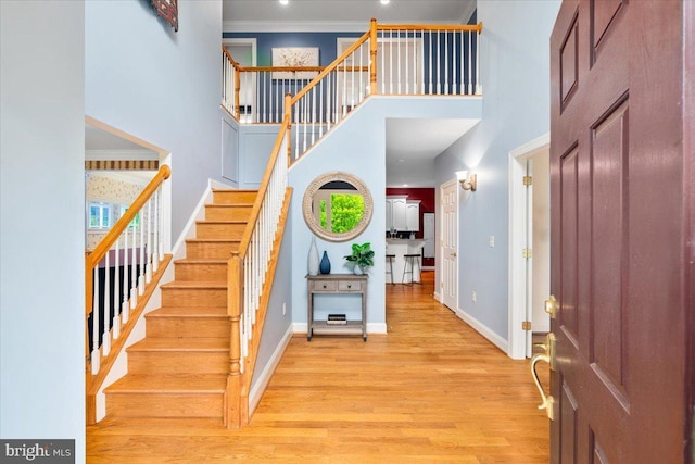 10840 Wolfsville Rd, Myersville, MD 21773 - entryway featuring a towering ceiling, stairway, wood finished floors, baseboards, and ornamental molding