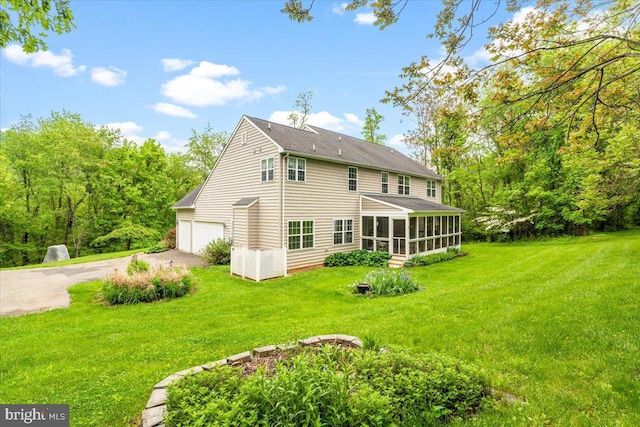 10840 Wolfsville Rd, Myersville, MD 21773 - back of property with driveway, a sunroom, a garage, a lawn, and roof with shingles