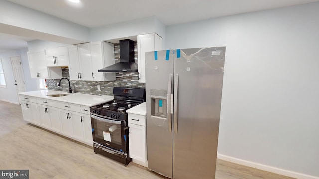 6 W Griffith St, Penns Grove, NJ 08069 - kitchen featuring wall chimney range hood, black gas range oven, a sink, stainless steel fridge, and decorative backsplash
