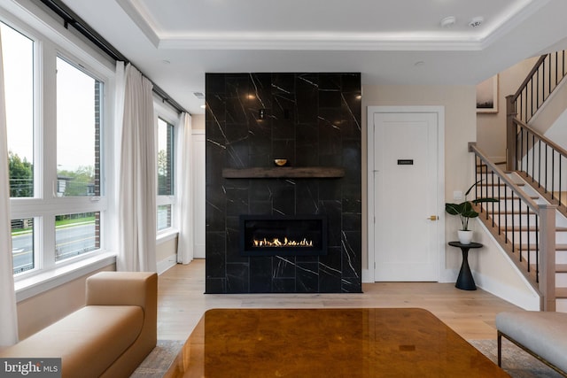1632 Chain Bridge Rd, Mclean, VA 22101 - living area with wood finished floors, stairway, a tray ceiling, a high end fireplace, and ornamental molding