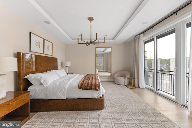1632 Chain Bridge Rd, Mclean, VA 22101 - bedroom with a tray ceiling, access to exterior, a chandelier, wood finished floors, and baseboards