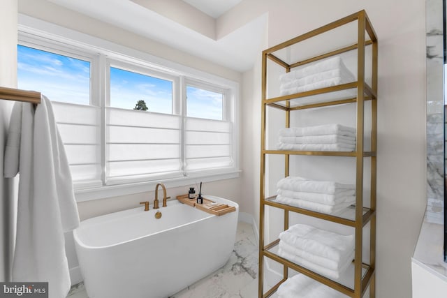 1632 Chain Bridge Rd, Mclean, VA 22101 - bathroom with marble finish floors, a soaking tub, and baseboards