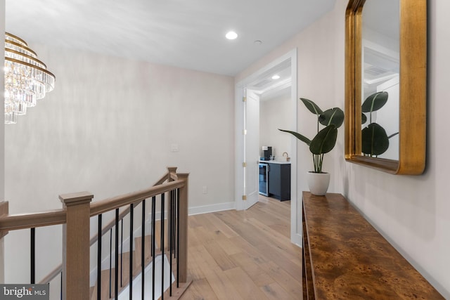 1632 Chain Bridge Rd, Mclean, VA 22101 - hall featuring an upstairs landing, light wood finished floors, recessed lighting, baseboards, and a chandelier