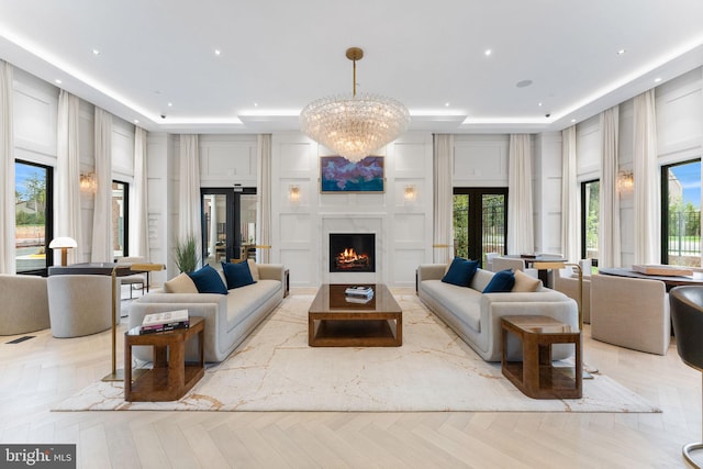 1632 Chain Bridge Rd, Mclean, VA 22101 - living room with a tray ceiling, a decorative wall, a fireplace, healthy amount of natural light, and recessed lighting