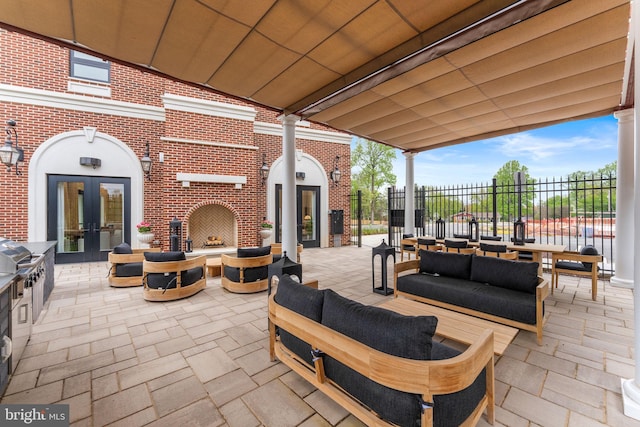 1632 Chain Bridge Rd, Mclean, VA 22101 - view of patio / terrace with french doors and an outdoor living space with a fireplace