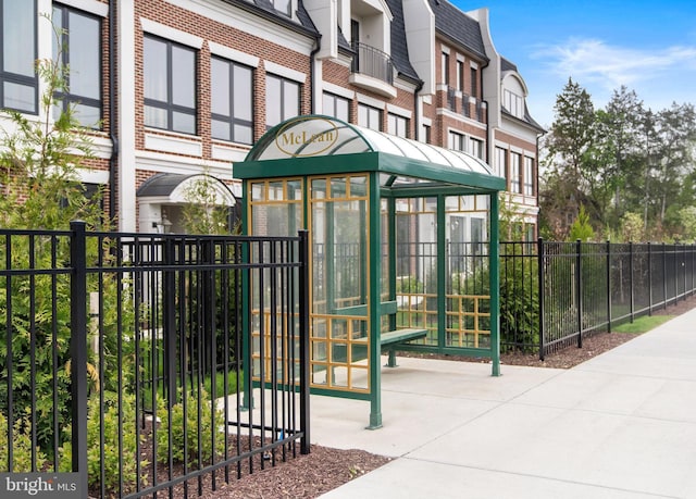 1632 Chain Bridge Rd, Mclean, VA 22101 - doorway to property featuring brick siding, mansard roof, and a shingled roof