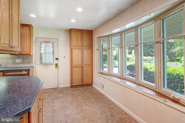 2306 Marline Ct, Woodbridge, VA 22192 - kitchen with dark countertops, tasteful backsplash, baseboards, recessed lighting, and light tile patterned floors