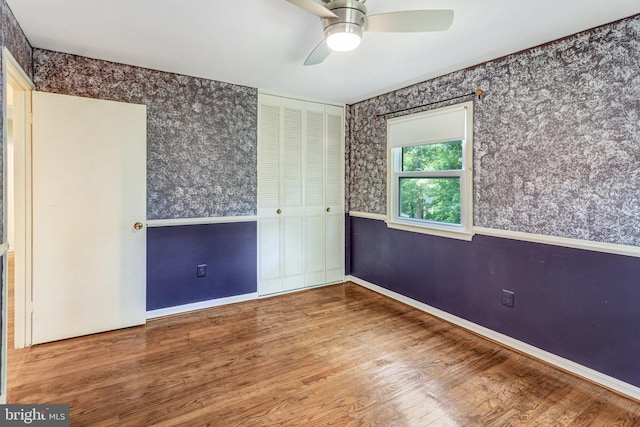 2306 Marline Ct, Woodbridge, VA 22192 - unfurnished bedroom featuring wallpapered walls, wood finished floors, baseboards, a closet, and ceiling fan