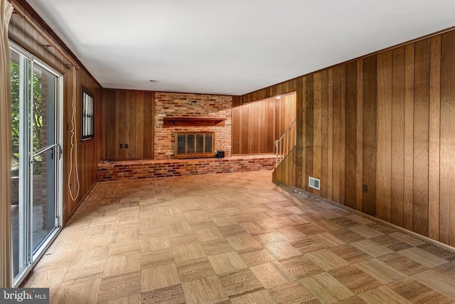 2306 Marline Ct, Woodbridge, VA 22192 - unfurnished living room featuring wood walls and a fireplace