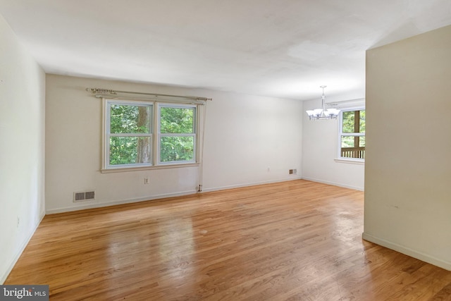 2306 Marline Ct, Woodbridge, VA 22192 - spare room with a chandelier, wood finished floors, and baseboards