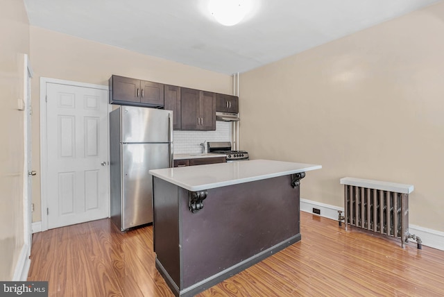 159 W Palmer St, Philadelphia, PA 19122 - kitchen featuring freestanding refrigerator, range, under cabinet range hood, light wood finished floors, and dark brown cabinets