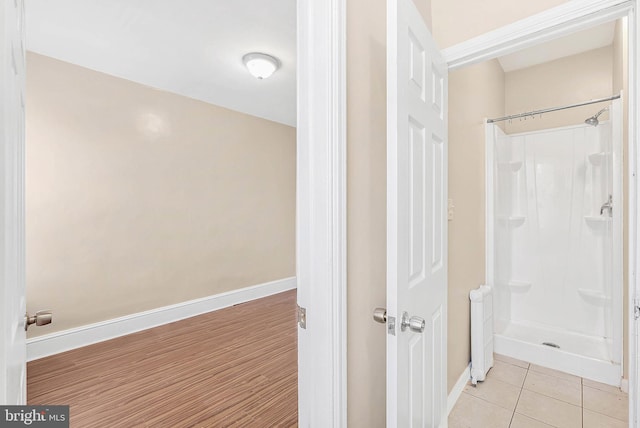 159 W Palmer St, Philadelphia, PA 19122 - bathroom featuring a shower stall, baseboards, and tile patterned floors